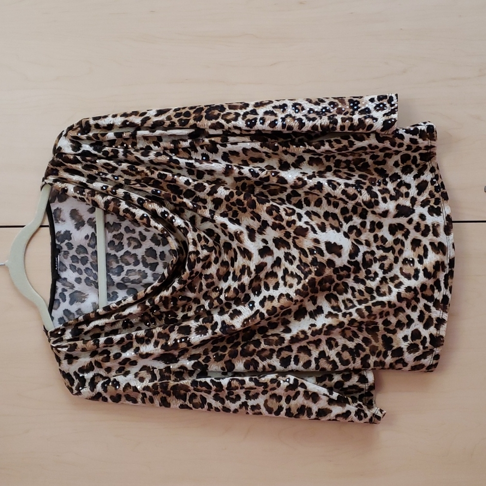 A leopard-print blouse with transparent sequins all throughout